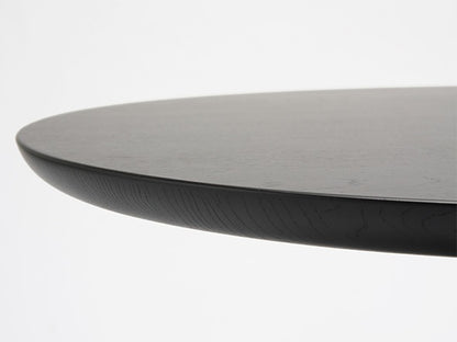 Table bistrot Scout — détail du chant biseauté du plateau rond en chêne teinté noir | Antifer