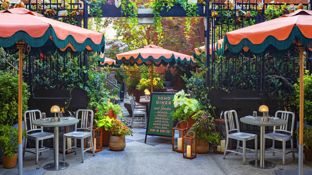 Emeco 1006 Navy in the garden of the Soho Grand Hotel, NYC — brushed aluminium outdoors | Antifer