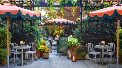 Emeco 1006 Navy in the garden of the Soho Grand Hotel, NYC — brushed aluminium outdoors | Antifer